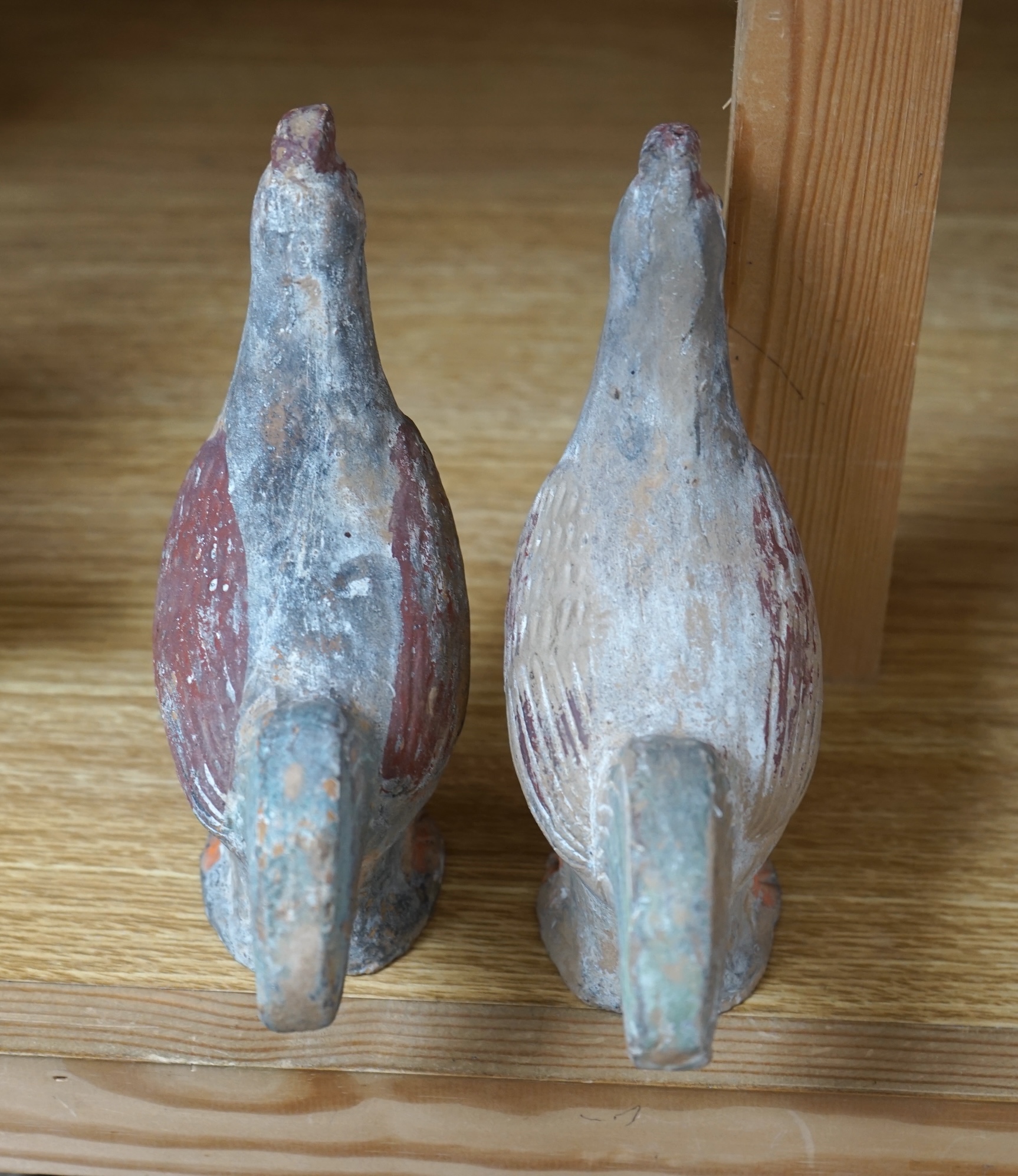 A pair of Chinese pottery figures of cockerels, Han Dynasty or later, height 17cm. Condition - fair